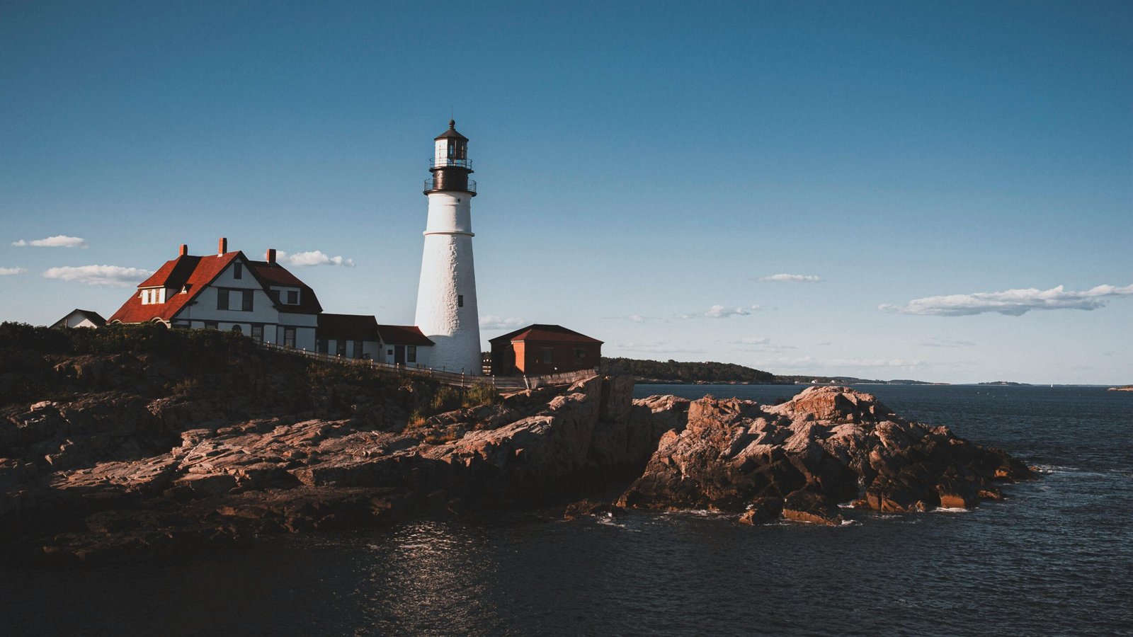 Scenic view of Portland Head Light, a famous lighthouse in Maine, along the rocky coastline.